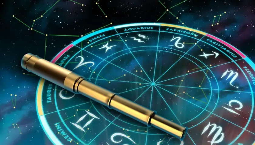 Złoty teleskop na tle koła zodiaku i konstelacji.